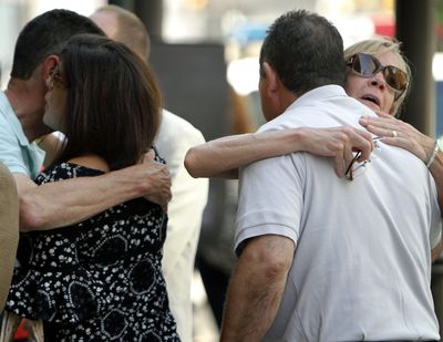 People hug before attending a memorial service at the Pennsylvania Academy of the Fine Arts in Philadelphia on Sunday. The service was for Anne Bryan, who was among the victims of a fatal building collapse in Philadelphia last week. (Associated Press)
