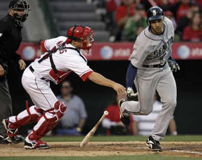 Los Angeles Angels catcher Jeff Mathis reaches to tag Seattle Mariners' Raul Ibanez at home plate in the fourth inning. Associated Press
 (Associated Press / The Spokesman-Review)
