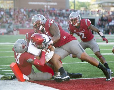 Eastern Washington running back Sam McPherson, shown scoring against Washington State, said the Eagle players expect an in-house hire to replace head coach Beau Baldwin. (Tyler Tjomsland / The Spokesman-Review)