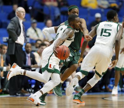 Miami guard Ja’Quan Newton (0) advances the ball as Michigan State guard Cassius Winston, defends in the second half of a first-round game in the men’s NCAA college basketball tournament in Tulsa, Okla., Friday March 17, 2017. (Tony Gutierrez / Associated Press)