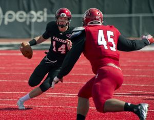 Eastern Washington University's Jordan West races up field against John Goldwire, 45,during the Red-White spring football game, April 26, 2014, at Roos Field in Cheney, Wash. (Dan Pelle)