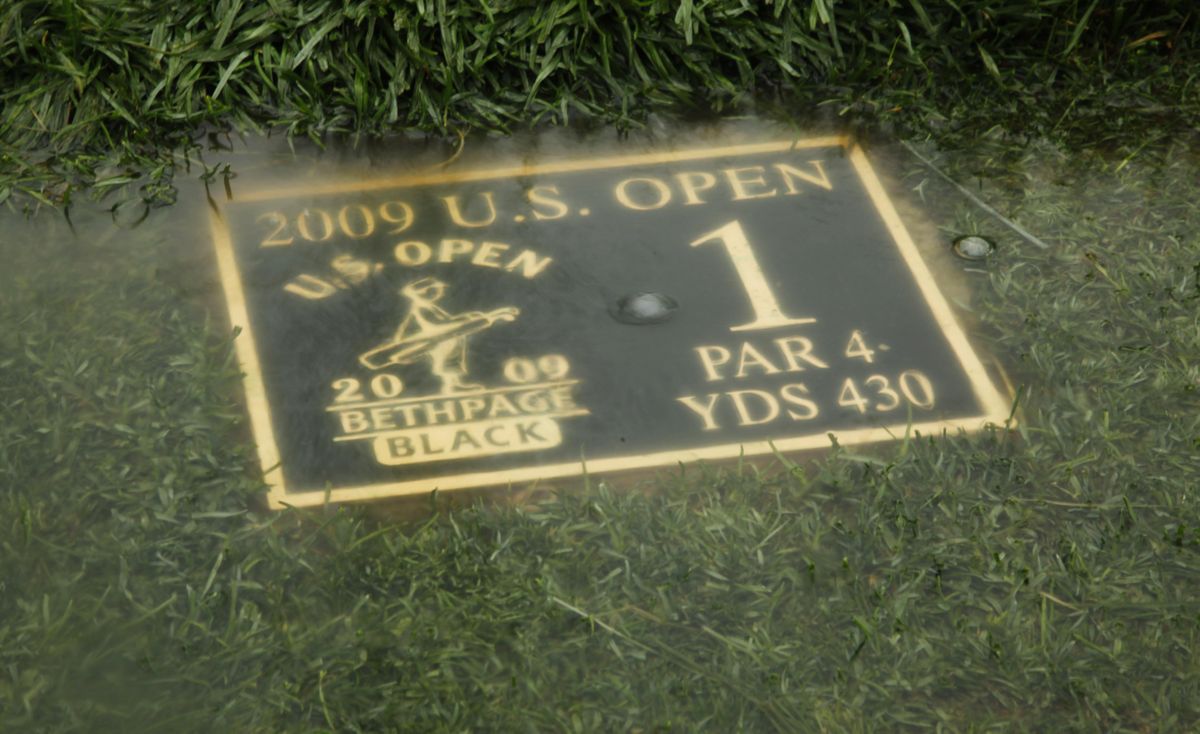 A yardage marker on the first tee sits under water at Bethpage State Park’s Black Course. Play was canceled at the U.S. Open because of inclement weather. (The Spokesman-Review)