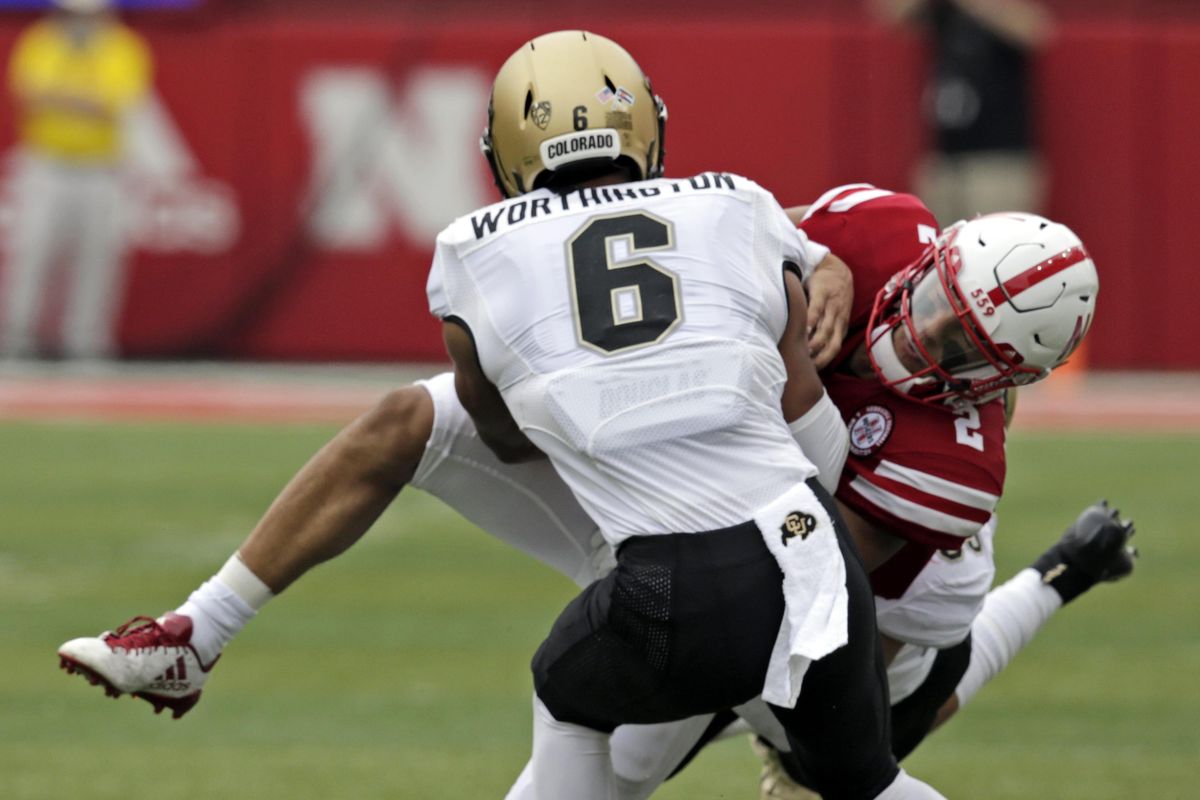 Nebraska quarterback Adrian Martinez  is tackled by Colorado defensive back Evan Worthington  during the first half Sept. 8  in Lincoln, Neb. (Nati Harnik / AP)