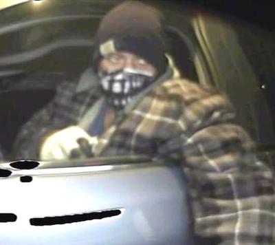 Screen capture of ATM surveillance video showing an unidentified person driving Bo Kirk’s vehicle and using his ATM card. (Post Falls Police Department)