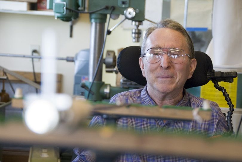 In this 2007 file photo, Tom Morgan, owner of Tom Morgan Rodsmiths, eyes up a rod at his workshop in Manhattan, Mont. Morgan spent his life in pursuit of crafting perfect fly fishing rods, regardless of cost, even after he was paralyzed by multiple sclerosis in the mid-1990s. He died Monday, June 12, 2017, of pneumonia. He was 76. (Ben Pierce / Bozeman Daily Chronicle via AP)