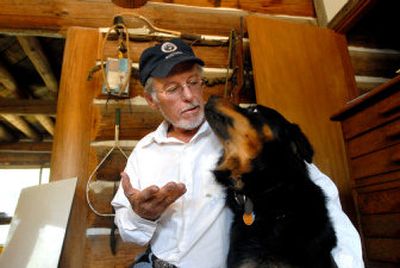 
Frank Wall of Athol sits with Flash, one of his 19 dogs. Neighbors have complained for years about the barking from his dogs, but Wall claims his neighbors incite them. 
 (JESSE TINSLEY Photos / The Spokesman-Review)