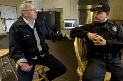 
Assistant Chief Dave Lobdell, left, talks with Deputy Sheriff Eric Epperson Tuesday about close encounters with drivers when they are on their way to emergencies with their emergency vehicle lights on.  