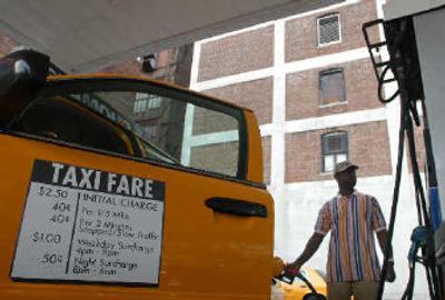 
Kenneth Senelorm, a New York City taxi driver, gases up at the end of his shift last week. Senelorm says that he has paid as much as $50 to fill his tank for a single shift and thinks that a small rate increase is a good idea. 
 (Associated Press / The Spokesman-Review)