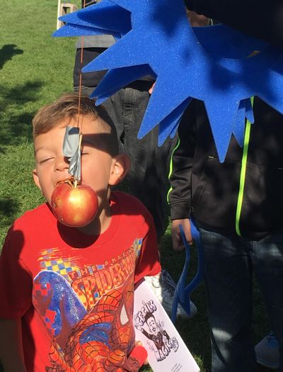 Isaiah Hallam, 5, tries his best to catch the apple in his mouth without using his hands at the second annual Hillyard Harvest Festival on Saturday, Oct. 3, 2015, in Spokane, Wash. (Nina Culver)