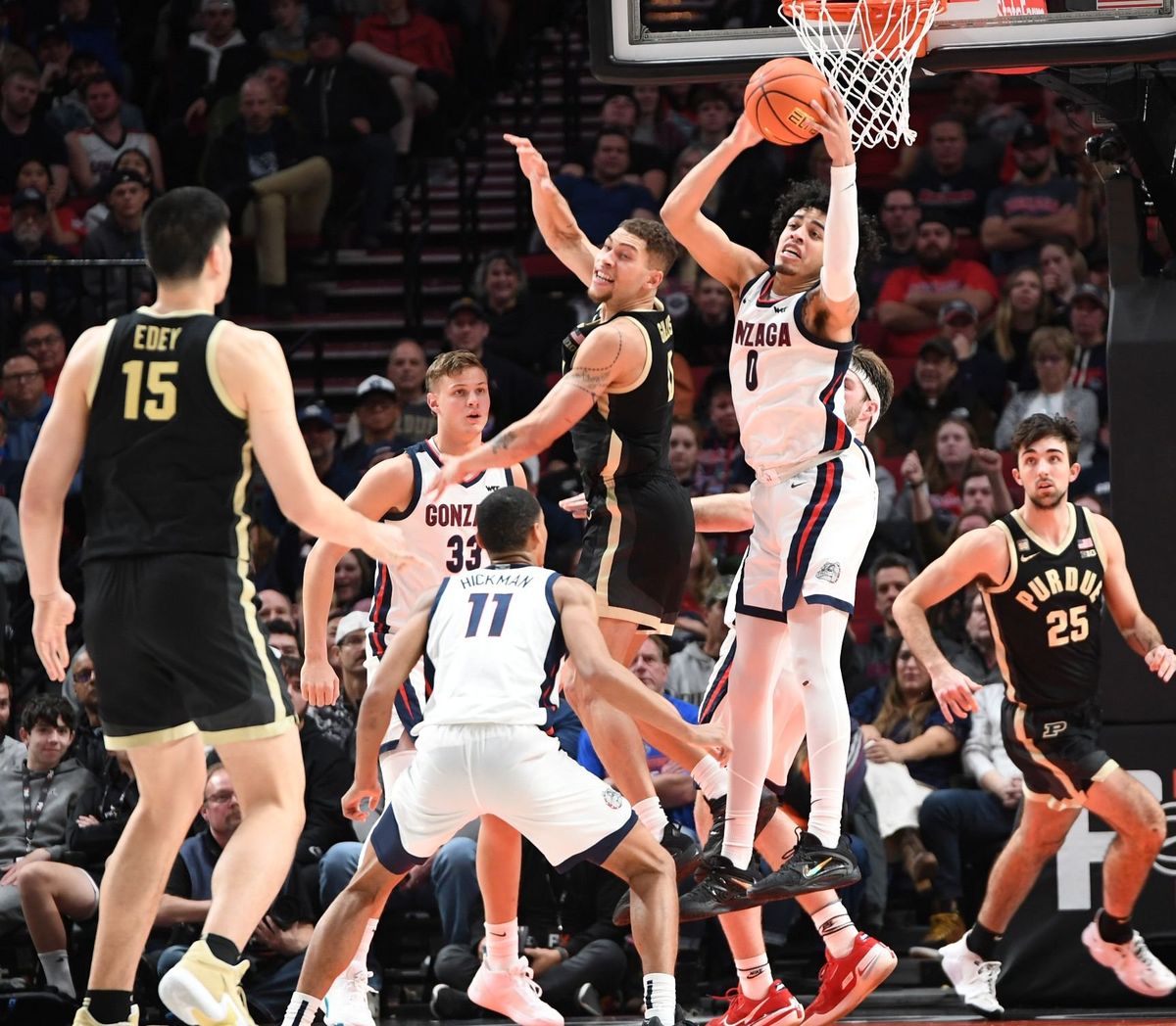 Gonzaga’s Julian Strawther grabs a defensive rebound, but the presence of Purdue’s Zach Edey hampers the fast break.  (Jesse Tinsley / The Spokesman-Review)