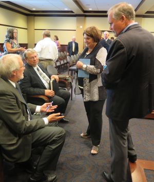 From left, Chief Deputy Idaho Secretary of State Tim Hurst, Secretary of State Lawerence Denney, Sen. Patti Anne Lodge and Sen. Marv Hagedorn talk campaign finance during a break in a legislative hearing on Wednesday, July 12, 2017. (Betsy Z. Russell)