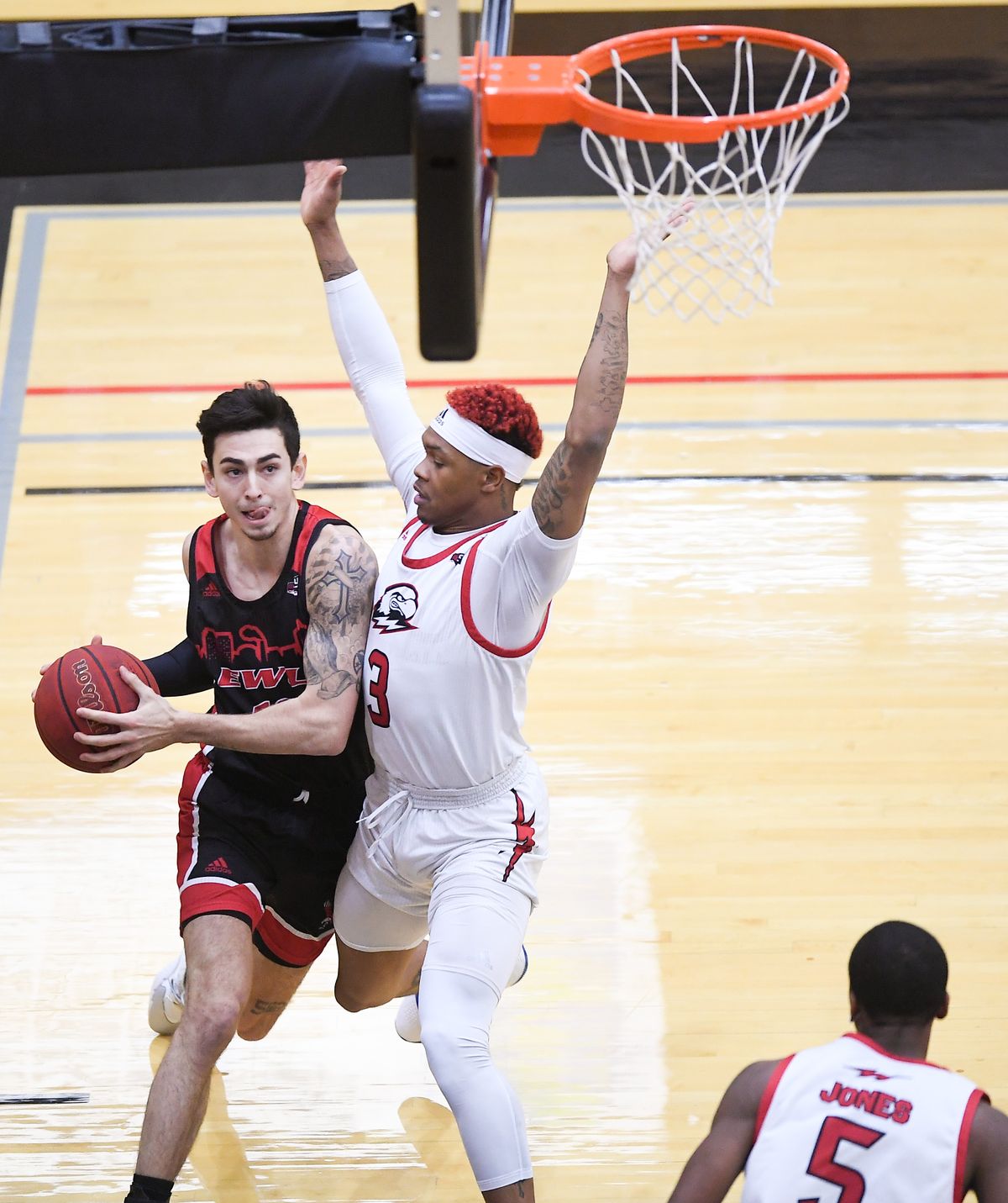 Eastern Washington Eagles guard Jacob Davison (10) drives to the hoop against Southern Utah Thunderbirds guard John Knight III (3) during the first half of a college basketball game on Saturday, January 16, 2021, at Reese Court in Cheney, Wash.  (Tyler Tjomsland/THE SPOKESMAN-RE)