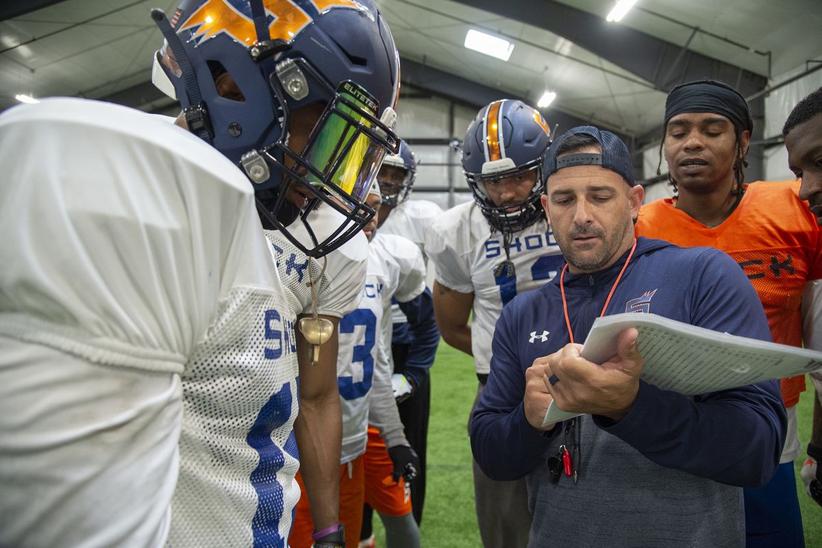 Spokane Shock Head Coach Billy Back, center, goes over plays with his offense during practice Monday at an indoor practice facility in North Idaho.  (Jesse Tinsley/The Spokesman-Review)