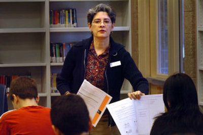
Ruth Hawley, an English as a Second Language teacher, instructs a group of ESL students on how to take a new state assessment test at Woodland Middle School in Coeur d'Alene on Friday.  The test involves reading, writing, listening and speaking. 
 (Jesse Tinsley / The Spokesman-Review)