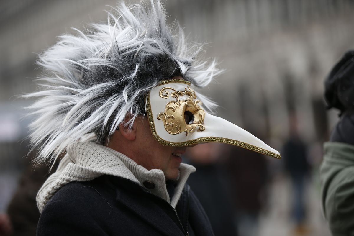 FILE - In this Jan. 24, 2016 file photo, a man wears a pest doctor mask in St. Mark