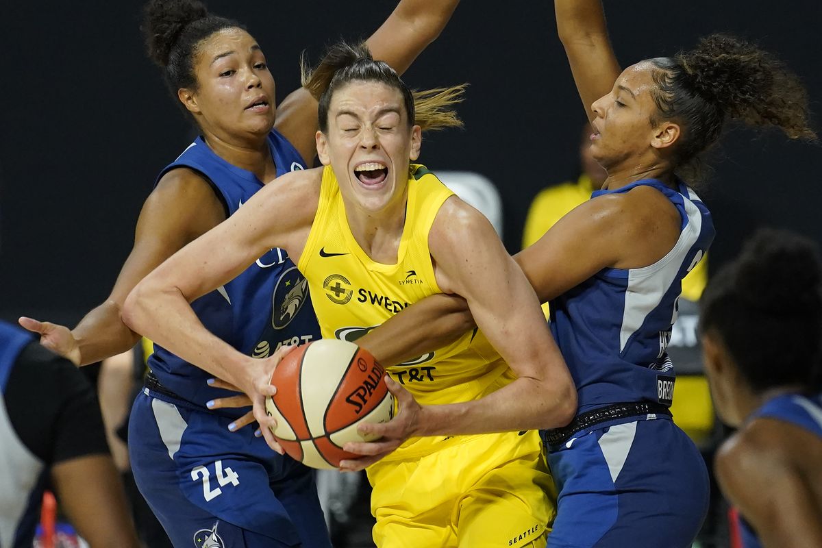 Storm forward Breanna Stewart is fouled by Minnesota’s Mikiah Herbert Harrigan, right, during Game 3 of a WNBA semifinal series Sept. 27 in Bradenton, Fla.  (Chris O