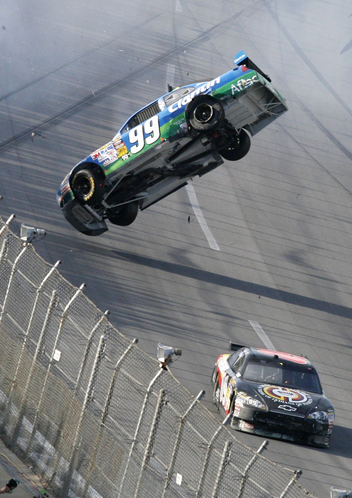 Carl Edwards’ car goes airborne after colliding with the car of Brad Keselowski, right. (Associated Press / The Spokesman-Review)