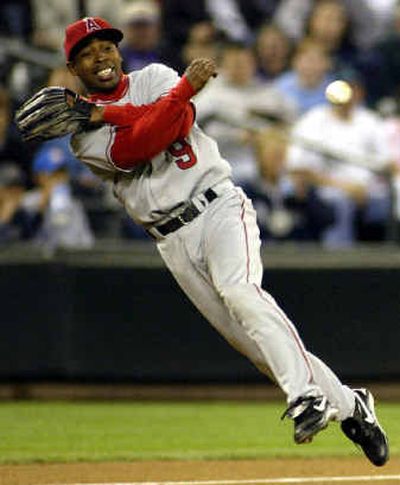 
Anaheim third baseman Chone Figgins whips a throw to first base, but Seattle's Raul Ibanez beat out the effort for a single.
 (Associated Press / The Spokesman-Review)