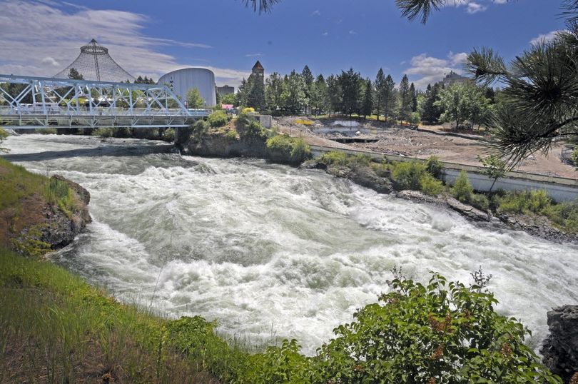 The Spokane River roars through Riverfront Park just below the site of the old YMCA building demolition on Thursday, June 23, 2011. The view from the park across the river has been greatly enhanced since the building was torn down. 
  (Christopher Anderson)