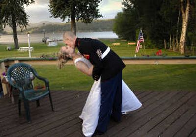 
Blissful moment: Lance Cpl. Matt Shipp plants a kiss on his bride, Jessica, after their wedding May 27 in Hauser Lake, Idaho. Matt and Jessica tied the knot during a break from his advanced training in the Marine Corps. Matt called Jessica three days before the wedding to say he had volunteered for early duty in Iraq.
 (Brian Plonka / The Spokesman-Review)