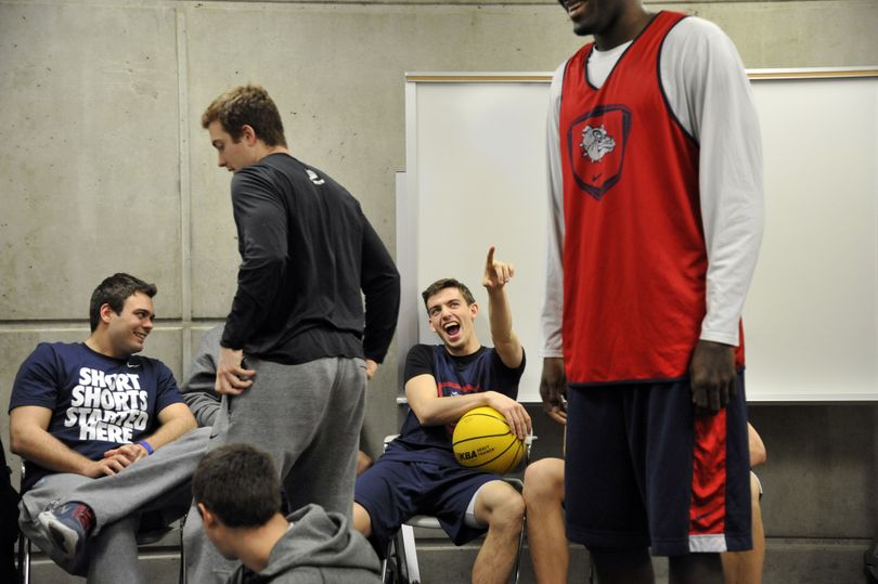 Gonzaga team manager Colin Stevens, left, and player David Stockton give teammate Sam Dower some good-natured ribbing in the team's locker room during press conference time at EnergySolutions Arena in Salt Lake City, UT.  The Zags are preparing to play Wichita State on Saturday evening. (The Spokesman-Review)