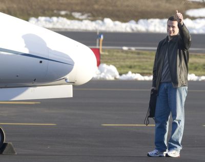 Bennett gives the “thumbs up” sign to fans standing behind a wire fence and calling his name, before he boarded a private jet Monday.Special to  (Tyler Tjomsland Special to / The Spokesman-Review)