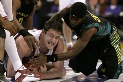 Washington State’s Aron Baynes holds onto the ball as Oregon’s Kamyron Brown tries to take it away during the first half. (Associated Press / The Spokesman-Review)