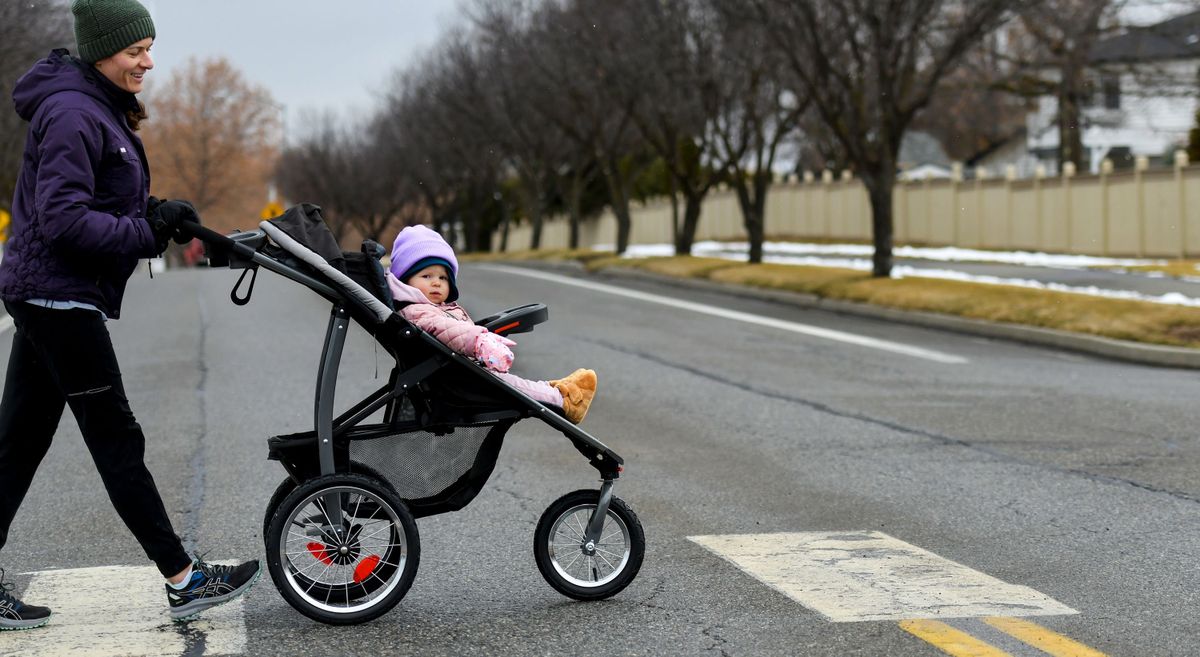 “I can’t believe that there aren’t more people out today,” says April Burfeind as she strolls her daughter Evelyn, 1, through their Liberty Lake neighborhood on Monday.  (KATHY PLONKA/THE SPOKESMAN-REVIEW)