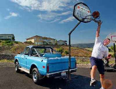 
Paul Carey, of Clarkston, tries out his Hoophitch, a trailer-hitch mounted basketball hoop that he invented. 
 (Kevin Nibur/ / The Spokesman-Review)