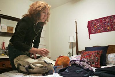 
Susan Ely packs for her trip with Peace Corps Encore! on Wednesday in Washington. Ely, a  Peace Corps veteran, was to leave  today  for a three-week assignment in India. 
 (Associated Press / The Spokesman-Review)