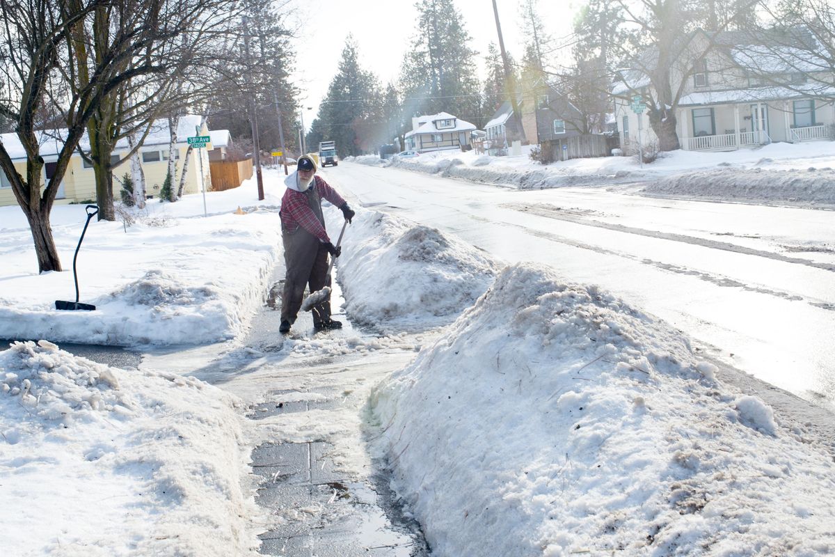 Handyman Dave Beckman, 55, shovels snow from a sidewalk on Jan. 19 in Spokane. "Business is good, but I can