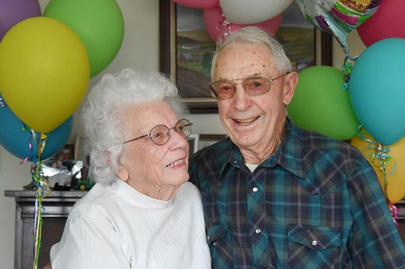 FloraBelle and Glenn Dobbins stand in their living room in rural Cheney Tuesday, Sept. 20, 2016, with some of the many photos and balloons they received when they recently celebrated their 70th anniversary. Glenn is 90, FloraBelle is 87. (Jesse Tinsley / The Spokesman-Review)