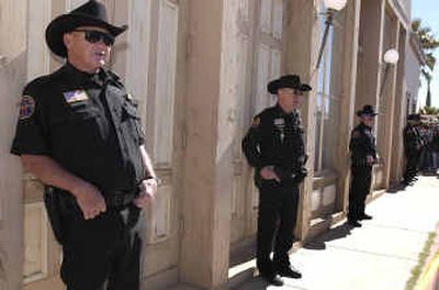
Members of the Arizona Rangers stand outside a building in Tombstone, Ariz., Friday to help the town marshals with crowd control during registration for the Minuteman Project. 
 (Associated Press / The Spokesman-Review)