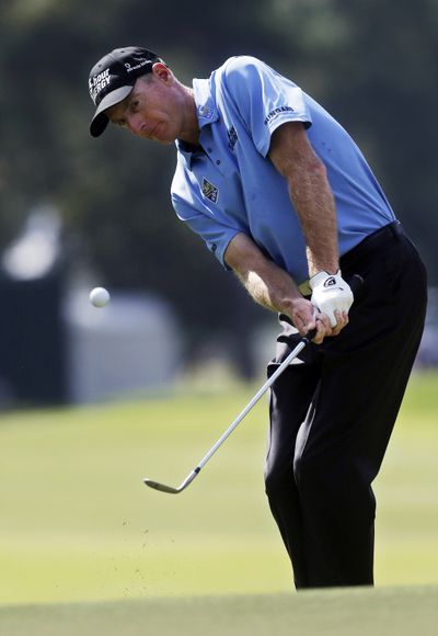Jim Furyk chips to the green on the 13th hole during the second round of the Tour Championship golf tournament. (Associated Press)