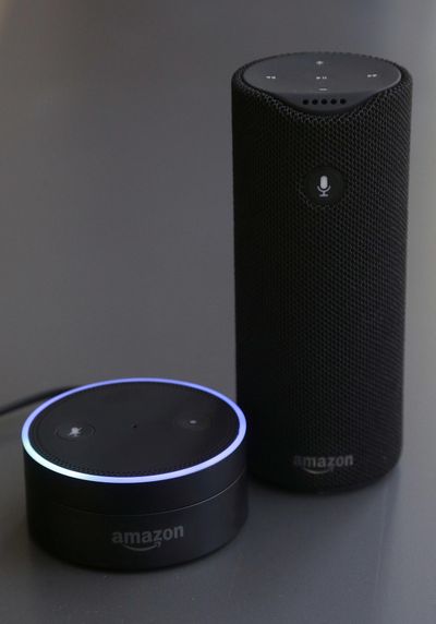 This  March 2  file photo shows an Echo Dot, left, and an Amazon Tap in San Francisco. The Amazon Echo, which listens to you, answers questions and carries out tasks like calling an Uber or turning on your lights, is finding a place in millions of living rooms. Amazon’s Alexa works primarily with Amazon’s Echo speakers, which compete with Google Home. (Jeff Chiu / Associated Press)