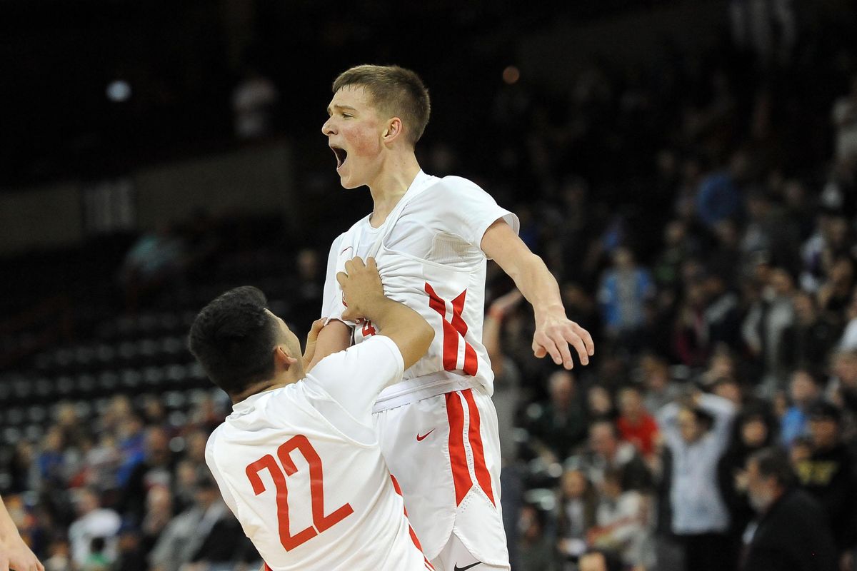 Brewster’s Cade Gebbers, right, celebrates after beating Life Christian Academy in the State 2B boys championship game on Saturday, March 7, 2020, at the Spokane Arena. (Kathy Plonka / The Spokesman-Review)