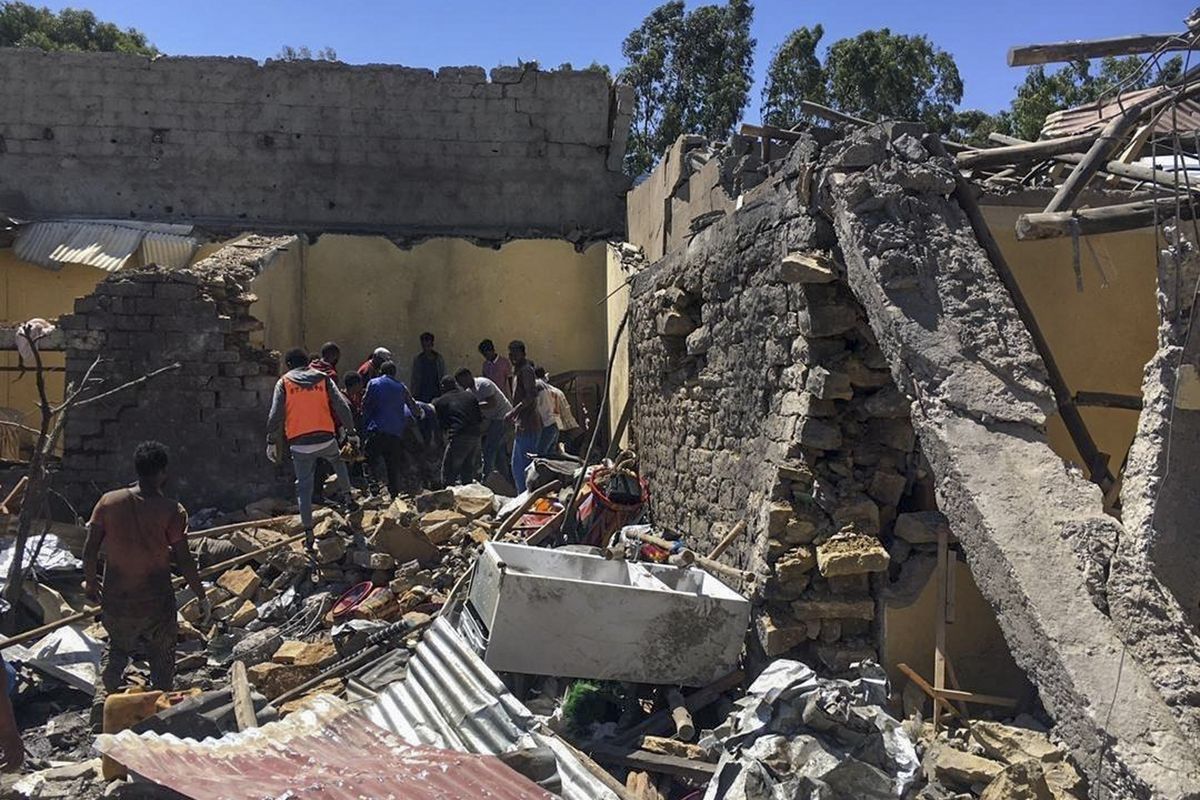 Residents sift through rubble from a destroyed building at the scene of an airstrike in Mekele, in the Tigray region of northern Ethiopia Thursday, Oct. 28, 2021. An Ethiopian government spokesman says a new airstrike has hit Mekele, targeting a site used by rival Tigray forces to make and repair weapons, while a Tigray spokesman instead says it struck a "civilian residence" killing six people and wounding more than 20.  (STR)