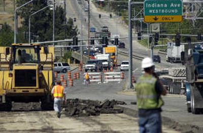 
Southbound traffic turns onto Indiana in Spokane Valley on Monday while crews tear up the Sullivan overpass in the foreground. 
 (Liz Kishimoto / The Spokesman-Review)