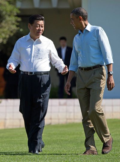 President Barack Obama and Chinese President Xi Jinping, left, walk at the Annenberg Retreat of the Sunnylands estate Saturday in Rancho Mirage, Calif. (Associated Press)
