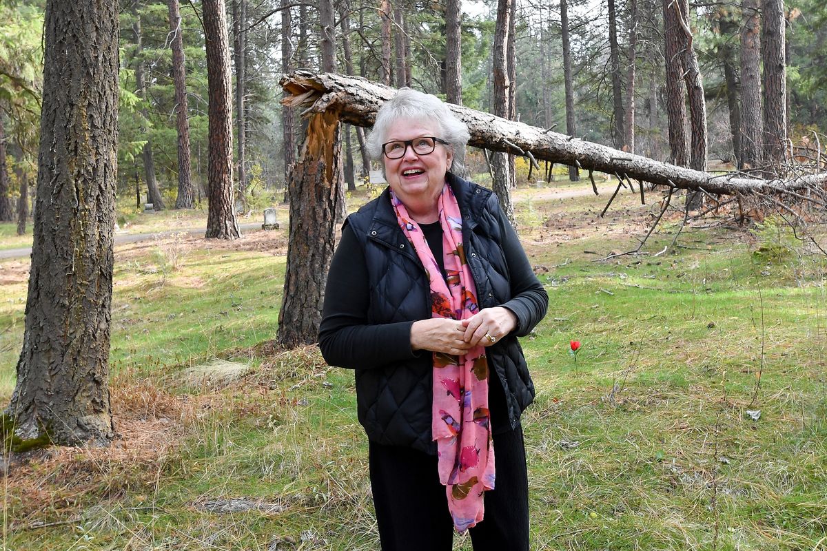 Nancy Larson smiles as she walks through potter’s field on Nov. 2 at Greenwood Memorial Terrace in Spokane. Larson visited the cemetery and found the graves in potter’s field neglected. She started with one gravesite, bringing dirt, water and planting flowers from her garden. Soon, she was caring for several more forgotten graves.  (Tyler Tjomsland/The Spokesman-Review)