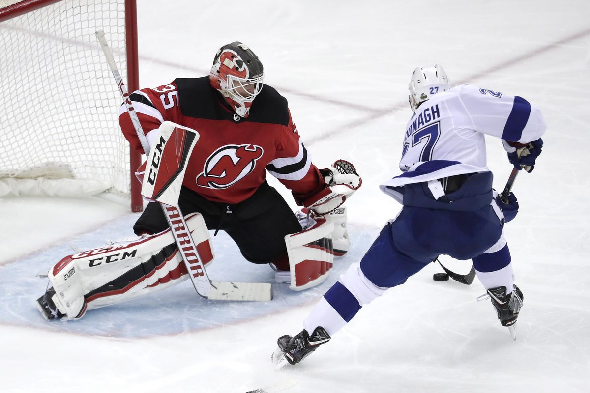 Tampa Bay Lightning defenseman Ryan McDonagh (27) attacks on New Jersey Devils goaltender Cory Schneider (35) during the third period of Game 3 of an NHL first-round hockey playoff series, Monday, April 16, 2018, in Newark, N.J. The Devils won 5-2. (Julio Cortez / Associated Press)