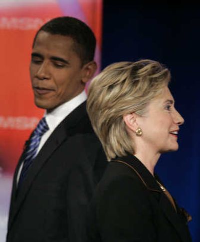 
Sen. Hillary Rodham Clinton, D-N.Y., and Sen. Barack Obama, D-Ill., pass each other during a break in  Tuesday's debate. Associated Press
 (Associated Press / The Spokesman-Review)