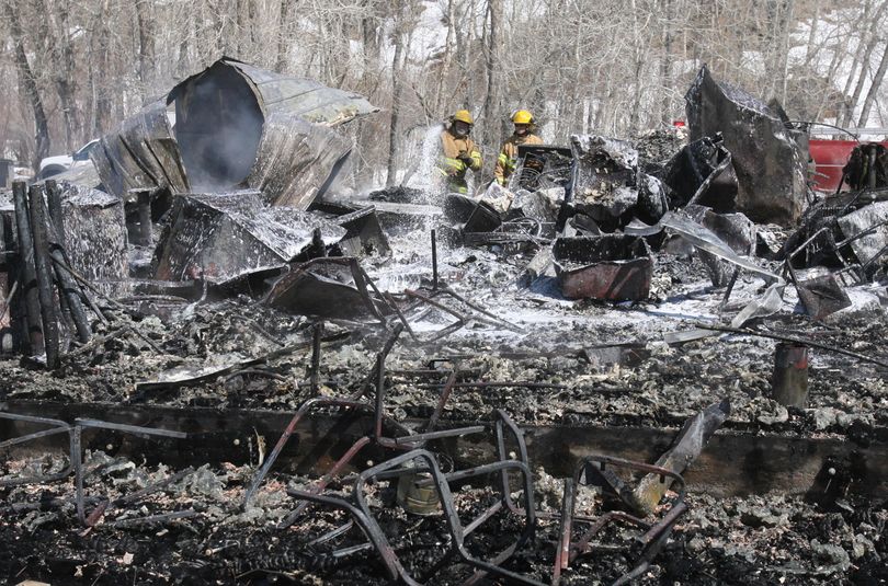 ORG XMIT: IDBOI104 Firefighters work to put out any remaining smolders from buildings at Soldier Mountain Ski Resort near Fairfield, Idaho that burned to the ground Monday, March 30, 2009. Investigators are trying to determine the cause of the Monday morning blaze that destroyed the main lodge at Soldier Mountain Ski Resort, a small ski operation owned by actor Bruce Willis. (AP Photo/The Idaho Statesman, Shawn Raecke) (Shawn Raecke / The Spokesman-Review)