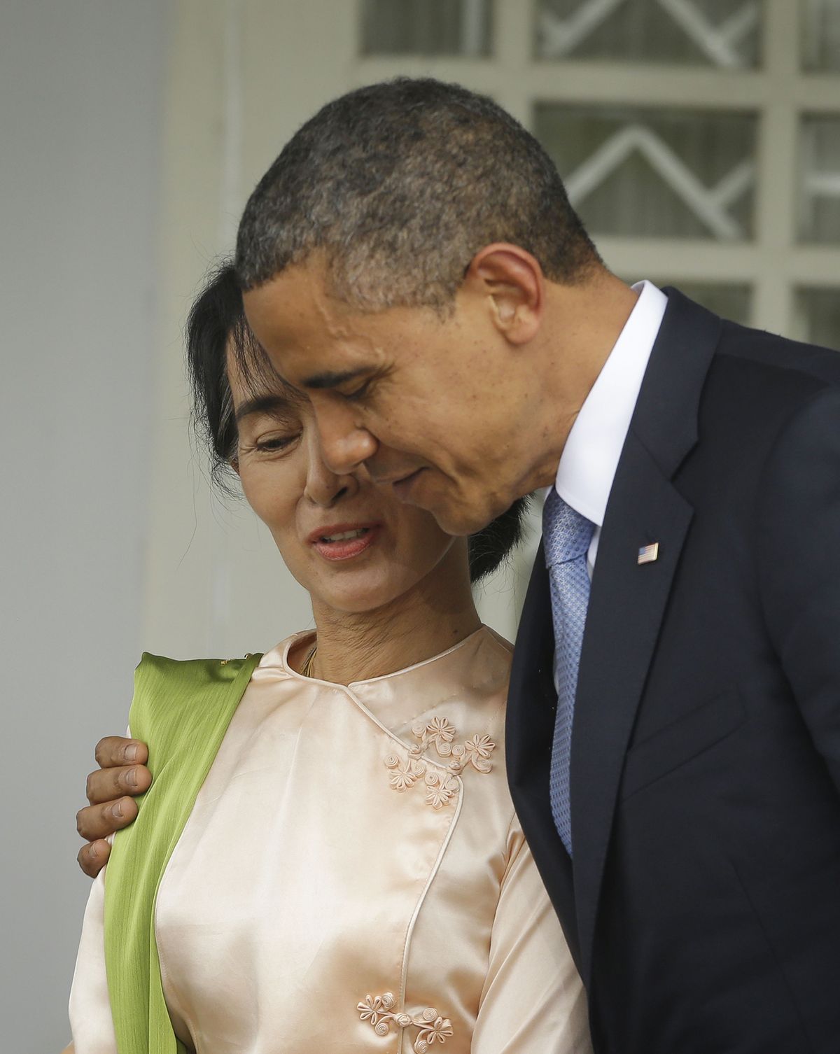 U.S. President Barack Obama, right, walks out with Myanmar opposition leader Aung San Suu Kyi after addressing members of the media at Suu Kyi