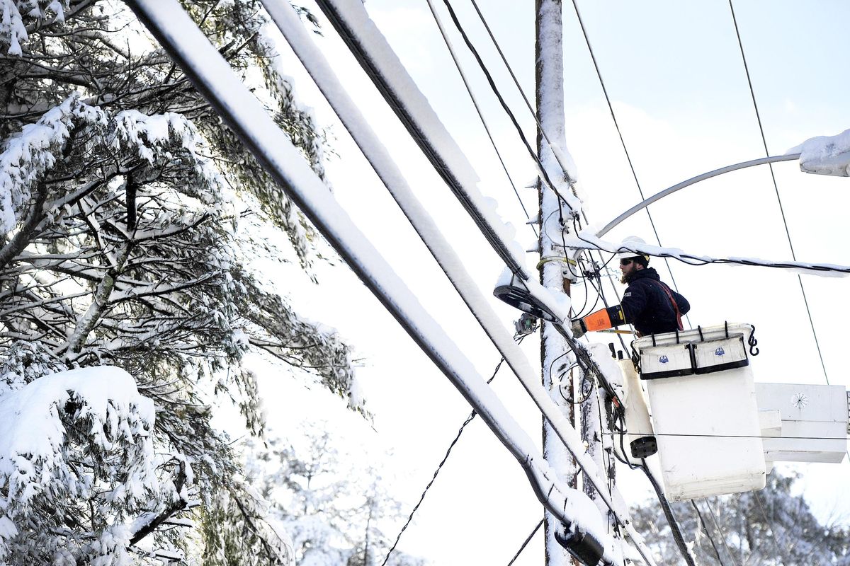 Justin Voight of On Target Utility works to restore power to a home along Main St. in Cumberland, Maine, Friday, Dec. 30, 2016. The most powerful nor’easter in nearly two years ,  shut down power to tens of thousands of residents Friday and  covered some towns under 2 feet of snow. (Shawn Patrick Ouellette / Associated Press)