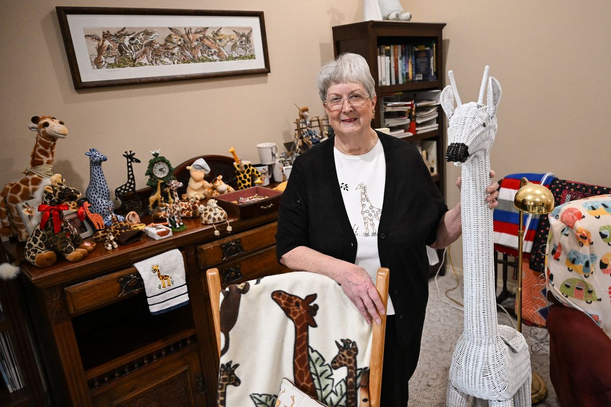 Florence Young shows off her collection of giraffe-related items on Dec. 19 at her home in Spokane. Young’s giraffe collection started when she was in fourth grade. She’d fallen off a swing and her parents gave her a china giraffe. She still has that one and more than 200 others.  (Tyler Tjomsland/The Spokesman-Review)