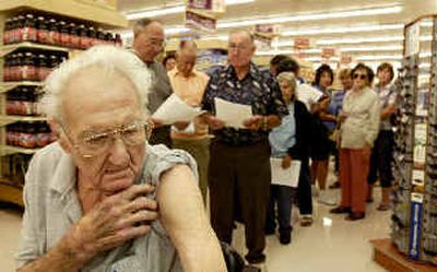 
Fred Mytar, 86, waits in line to get a flu shot at Pavilions pharmacy in Monrovia, Calif., on Thursday. Health officials nationwide are urging healthy adults and schoolchildren to skip the shot. 
 (Associated Press / The Spokesman-Review)