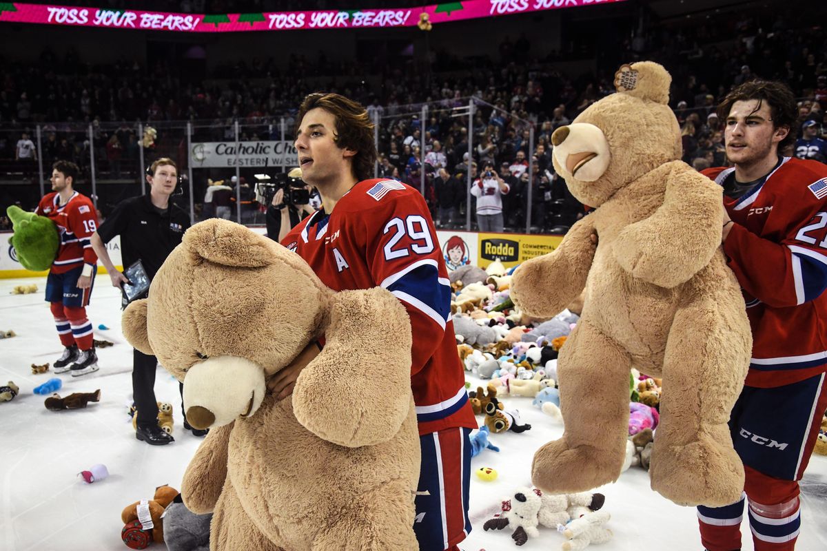 Spokane Chiefs Eli Zummack (29) and Bobby Russell haul away a pair of over-sized stuffed animals during Teddy Bear Toss night Saturday. (Dan Pelle / The Spokesman-Review)
