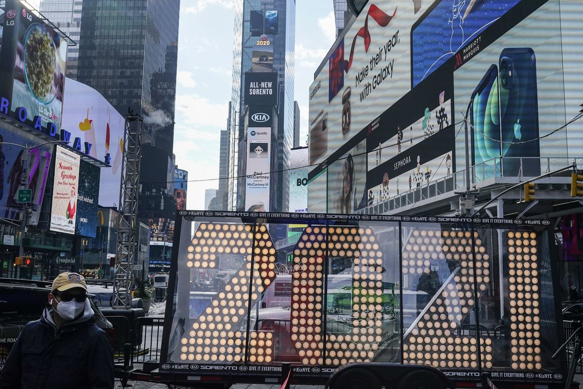 A man walks past giant numerals for “2021” to be used in the upcoming the New Year’s eve festivities in New York’s Times Square on Dec. 21.  (Frank Franklin II)