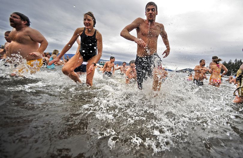 Polar Bear Plunge participants dash into Lake Coeur d’Alene in celebration of New Year’s Day.